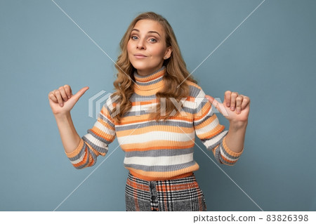 Portrait photo of young pretty beautiful attractive blonde woman with wavy-hair wearing striped Portrait photo of young pretty beautiful attractive blonde woman with wavy-hair wearing striped 83826398