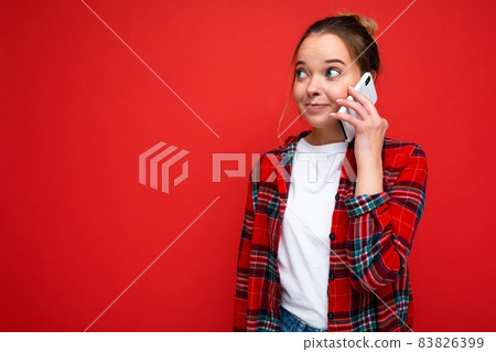 Photo of young attractive beautiful positive amazed blonde woman in stylish red shirt. Sexy carefree Photo of young attractive beautiful positive amazed blonde woman in stylish red shirt. Sexy carefree 83826399