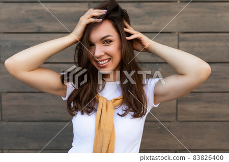 Close-up photo of pretty attractive beautiful smiling happy positive charming young brunette young Close-up photo of pretty attractive beautiful smiling happy positive charming young brunette young 83826400
