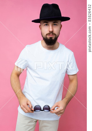 Vertical photo shot of confident brutal good looking young brunet bearded man wearing casual white t 83826432