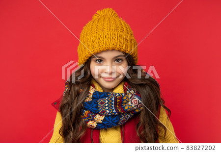 winter fashion. cheerful kid with curly hair in hat. female fashion model. teen girl in scarf. winter fashion. cheerful kid with curly hair in hat. female fashion model. teen girl in scarf. 83827202