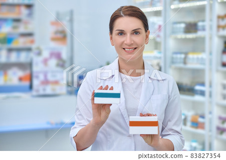 Woman pharmacist with medicines in hands 83827354