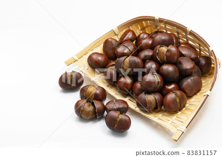 Sweet chestnuts with shells on a colander 83831157