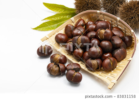 Sweet chestnuts with shells on a colander 83831158