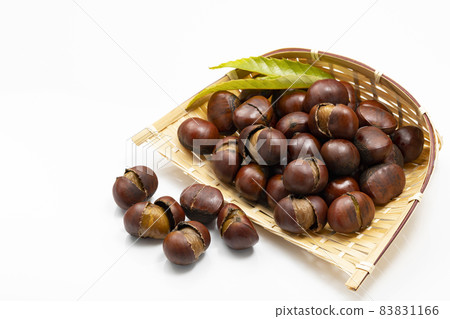 Sweet chestnuts with shells on a colander 83831166