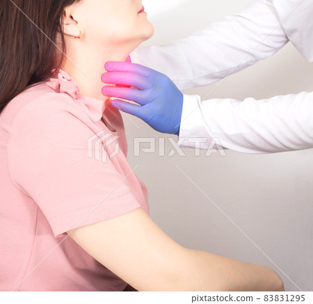 A neurologist doctor checks the throat of a girl who has a lump in her throat, dryness and soreness. Neurological Emotional Disorder Concept A neurologist doctor checks the throat of a girl who has a lump in her throat, dryness and soreness. Neurological Emotional Disorder Concept 83831295