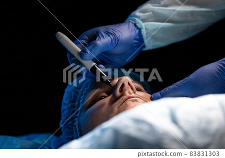 Plastic surgery to change the shape and size of the girl's nostrils. Rhinoplasty of the nose. Close-up Plastic surgery to change the shape and size of the girl's nostrils. Rhinoplasty of the nose. Close-up 83831303