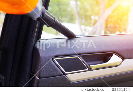 Dry cleaning in the passenger compartment of a car with a car vacuum cleaner from dust and dirt, background. Comfortable 83831364