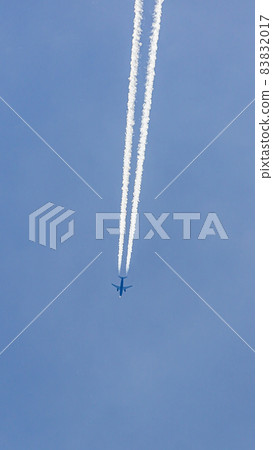 Two engined airplane during flight in high altitude with condensation trails Two engined airplane during flight in high altitude with condensation trails 83832017