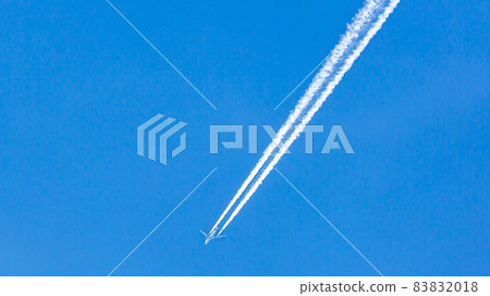 Two engined airplane during flight in high altitude with condensation trails Two engined airplane during flight in high altitude with condensation trails 83832018