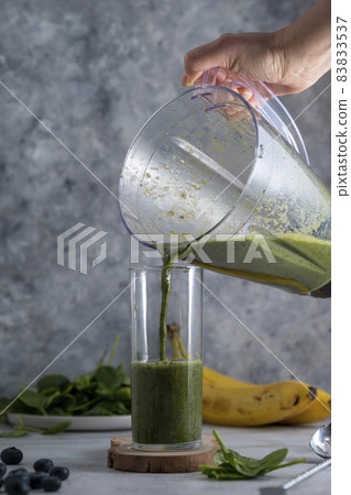 Green spinach, banana and blueberry smoothie. Healthy vegan juice drink. Green spinach, banana and blueberry smoothie. Healthy vegan juice drink. 83833537