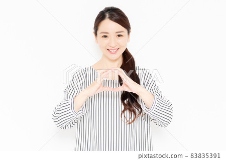 A casually dressed woman in an OK pose A casually dressed woman in an OK pose 83835391