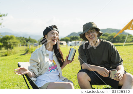 Men and women drinking alcohol at the campsite Men and women drinking alcohol at the campsite 83836520
