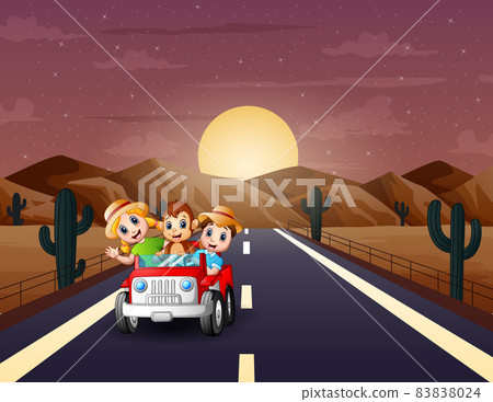 Happy children driving a car through desert road Happy children driving a car through desert road 83838024