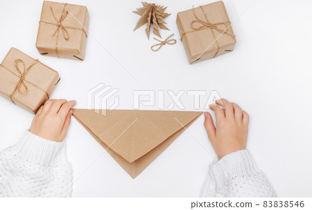 Christmas tree origami paper craft. The child performs the Step-by-step instruction. Step 8 of 23 . DIY concept 83838546
