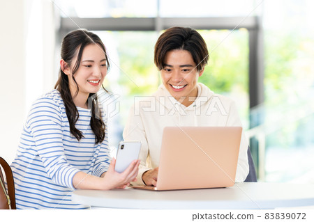 Male and female college students looking at a computer at school "LINK FOREST" Male and female college students looking at a computer at school "LINK FOREST" 83839072