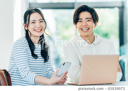 Male and female college students looking at a computer at school "LINK FOREST" Male and female college students looking at a computer at school "LINK FOREST" 83839073