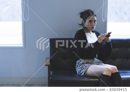 Cool lady using a smartphone Cool lady using a smartphone 83839415