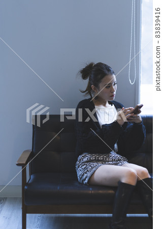 Cool lady using a smartphone Cool lady using a smartphone 83839416