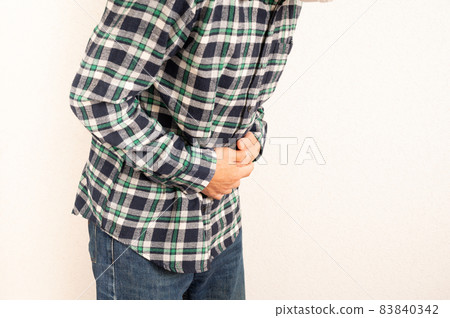 Middle man suffers from abdominal pain Middle man suffers from abdominal pain 83840342