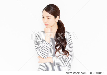 A woman in casual clothes who is in trouble due to worries A woman in casual clothes who is in trouble due to worries 83840846