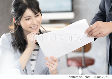 A woman confirming a document 83842030