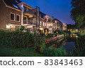 Illuminated houses in the evening Amsterdam 83843463