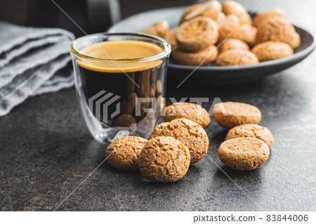 Amaretti biscuits. Sweet italian almond cookies and coffee cup 83844006