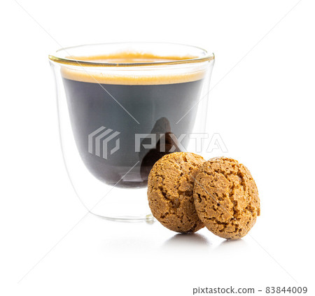Amaretti biscuits. Sweet italian almond cookies and coffee cup Amaretti biscuits. Sweet italian almond cookies and coffee cup 83844009