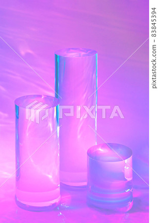 three clear glass cylinder podiums on pastel pink background three clear glass cylinder podiums on pastel pink background 83845394