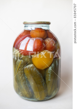 spoiled can of vegetable seaming. Glass jar with homemade pickled tomatos and cucumbers with white fungus spoiled can of vegetable seaming. Glass jar with homemade pickled tomatos and cucumbers with white fungus 83845707