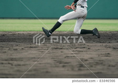 A baseball player trying to steal a base during a baseball game A baseball player trying to steal a base during a baseball game 83846566
