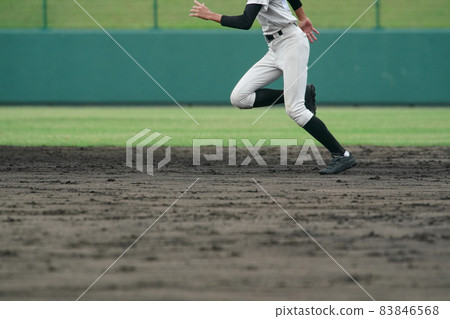 A baseball player trying to steal a base during a baseball game 83846568
