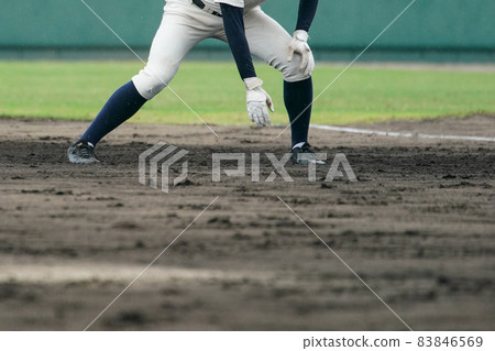 A baseball player trying to steal a base during a baseball game 83846569