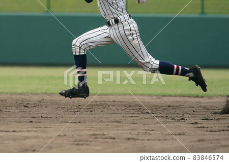 A baseball player trying to steal a base during a baseball game 83846574