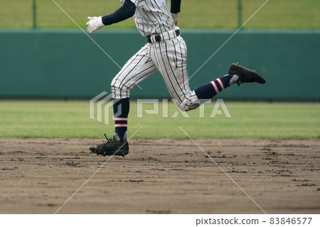 A baseball player trying to steal a base during a baseball game A baseball player trying to steal a base during a baseball game 83846577
