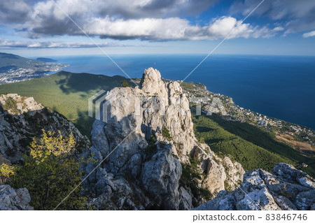 High rocks Ai-Petri of Crimean mountains. Black sea coast and blue sky with clouds in autumn. Russia High rocks Ai-Petri of Crimean mountains. Black sea coast and blue sky with clouds in autumn. Russia 83846746