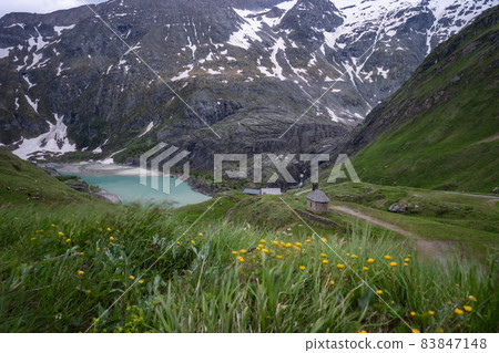 Solitary chapel near the emerald green Margaritze stausee lake on the Grossglockner High Alpine Road Solitary chapel near the emerald green Margaritze stausee lake on the Grossglockner High Alpine Road 83847148