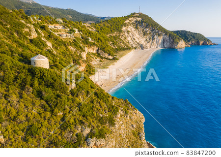 Aerial view of Milos beach near the Agios Nikitas village on Lefkada Ionian island, Greece. Evening sunset golden light Aerial view of Milos beach near the Agios Nikitas village on Lefkada Ionian island, Greece. Evening sunset golden light 83847200