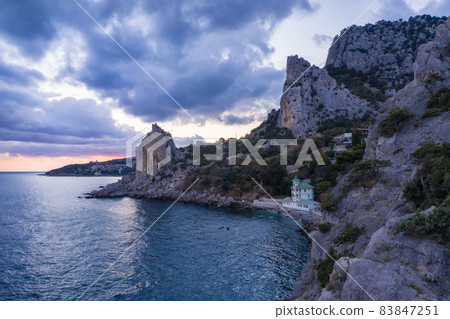 Aerial view of Simeiz village, Cat mountain in evening sunset light, Crimea. Black Sea 83847251