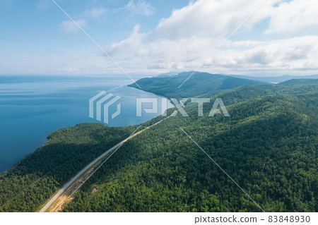 Summertime imagery of Lake Baikal is a rift lake located in southern Siberia, Russia Baikal lake summer landscape view from a cliff near Grandma's Bay. Drone's Eye View. 83848930