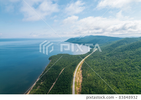 Summertime imagery of Lake Baikal is a rift lake located in southern Siberia, Russia Baikal lake summer landscape view from a cliff near Grandma's Bay. Drone's Eye View. 83848932