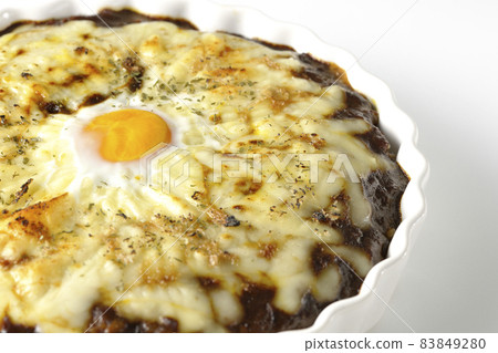 Photographed a grilled curry with plenty of melting cheese and eggs on a white background Photographed a grilled curry with plenty of melting cheese and eggs on a white background 83849280