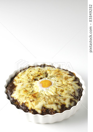 Photographed a grilled curry with plenty of melting cheese and eggs on a white background Photographed a grilled curry with plenty of melting cheese and eggs on a white background 83849282