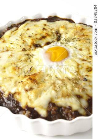 Photographed a grilled curry with plenty of melting cheese and eggs on a white background Photographed a grilled curry with plenty of melting cheese and eggs on a white background 83849284