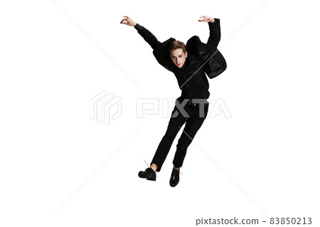 Young man in black business suit dancing isolated on white background. Art, motion, action, flexibility, inspiration concept. Young man in black business suit dancing isolated on white background. Art, motion, action, flexibility, inspiration concept. 83850213