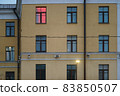 Old residetial building exterior in the city Moscow in autumn day. Close up photography. One window with pink lighting. Lifestyle concept 83850507
