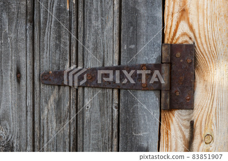 rusty metal door hinge. 83851907