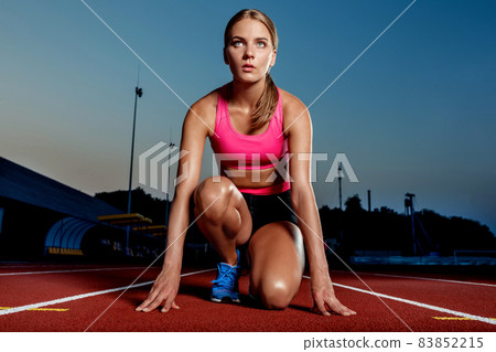 Portrait of beautiful woman ready to start running. Portrait of beautiful woman ready to start running. 83852215