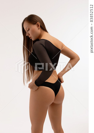 Crop graceful woman with crossed arms posing in studio Crop graceful woman with crossed arms posing in studio 83852512